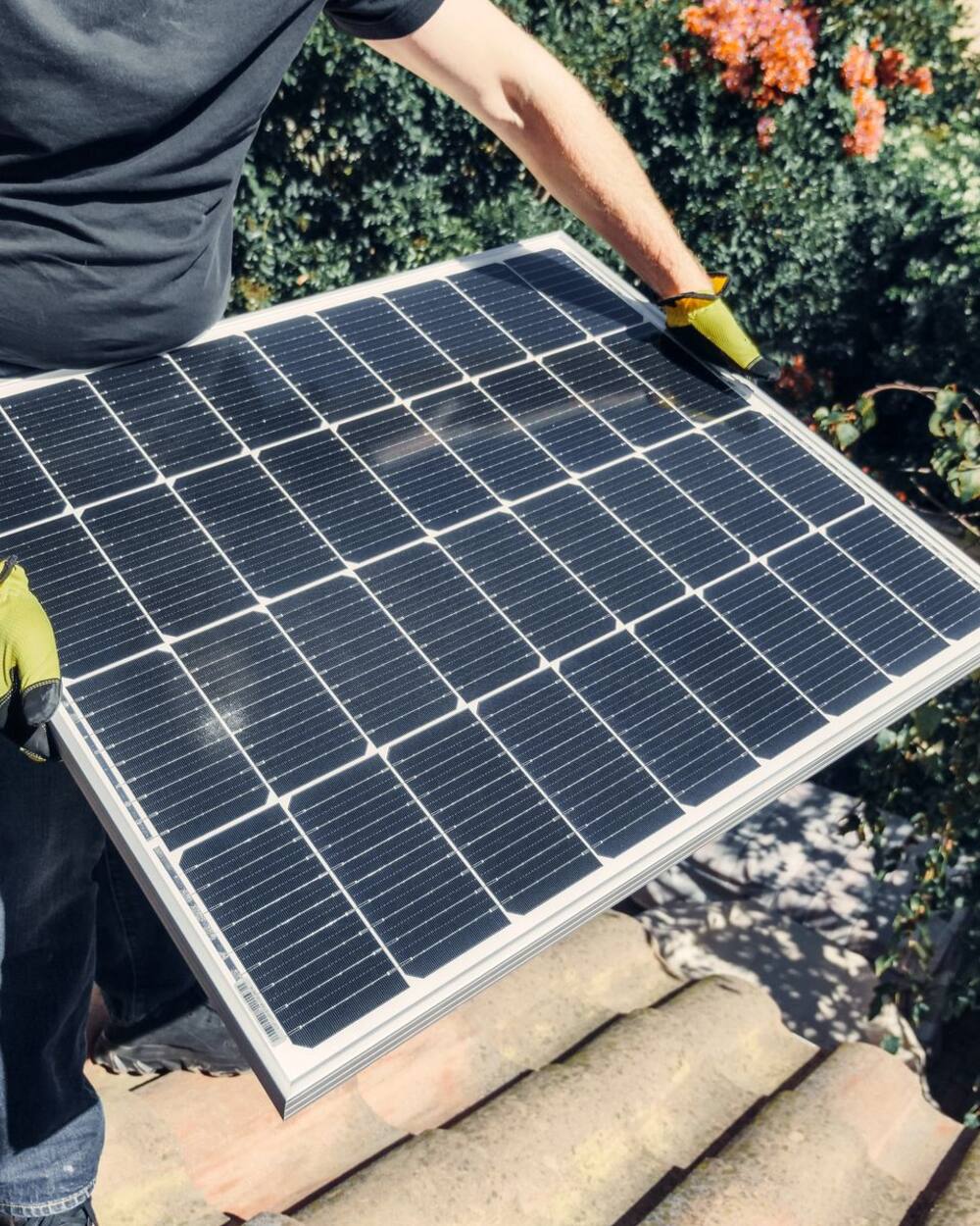 Técnico instalando paneles solares en el techo de una casa en Puebla